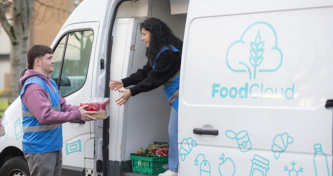 Employee donating stock to a Foodcloud Volunteer in a van
